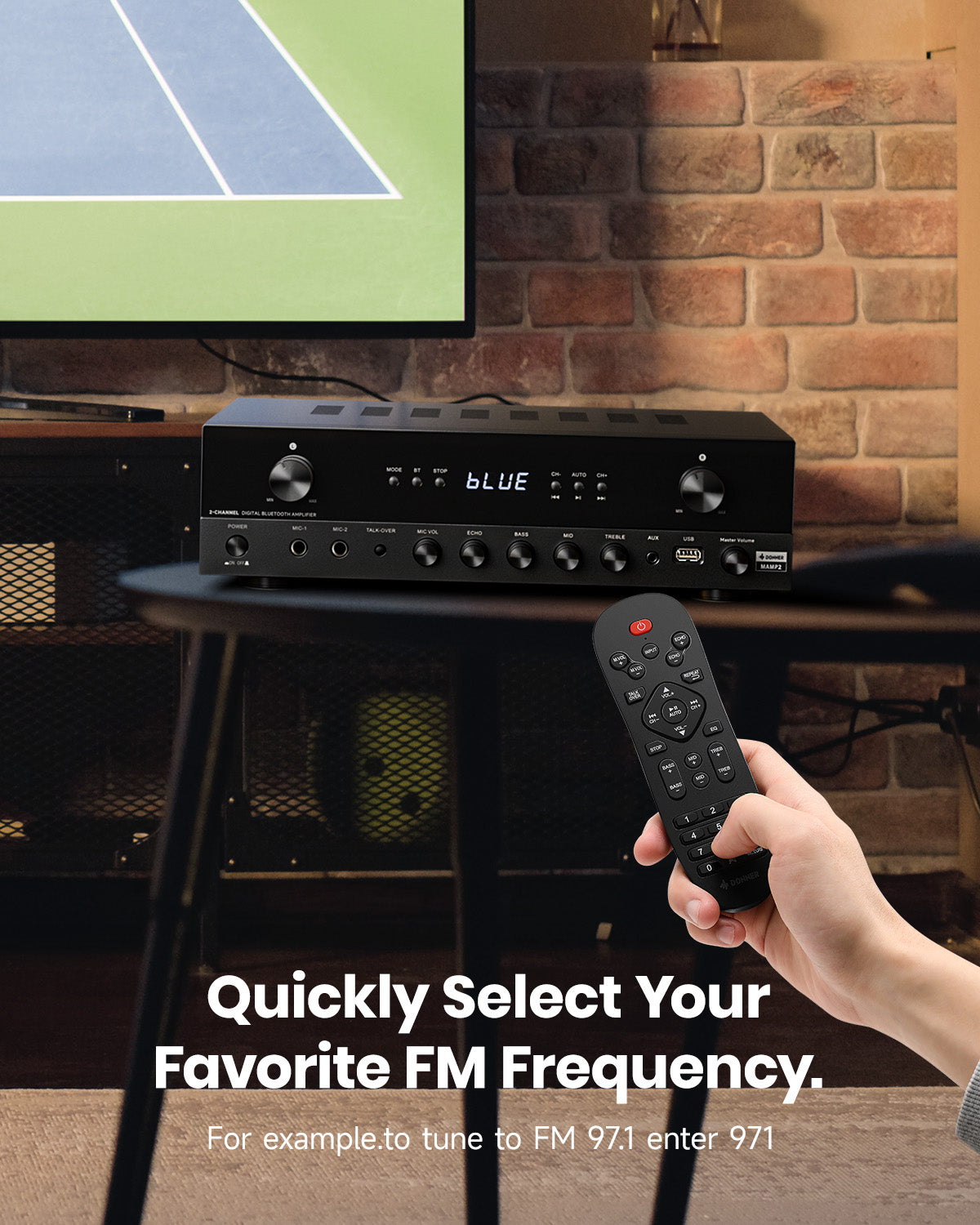 Black audio receiver with remote control in front of a brick wall and screen displaying a tennis court.